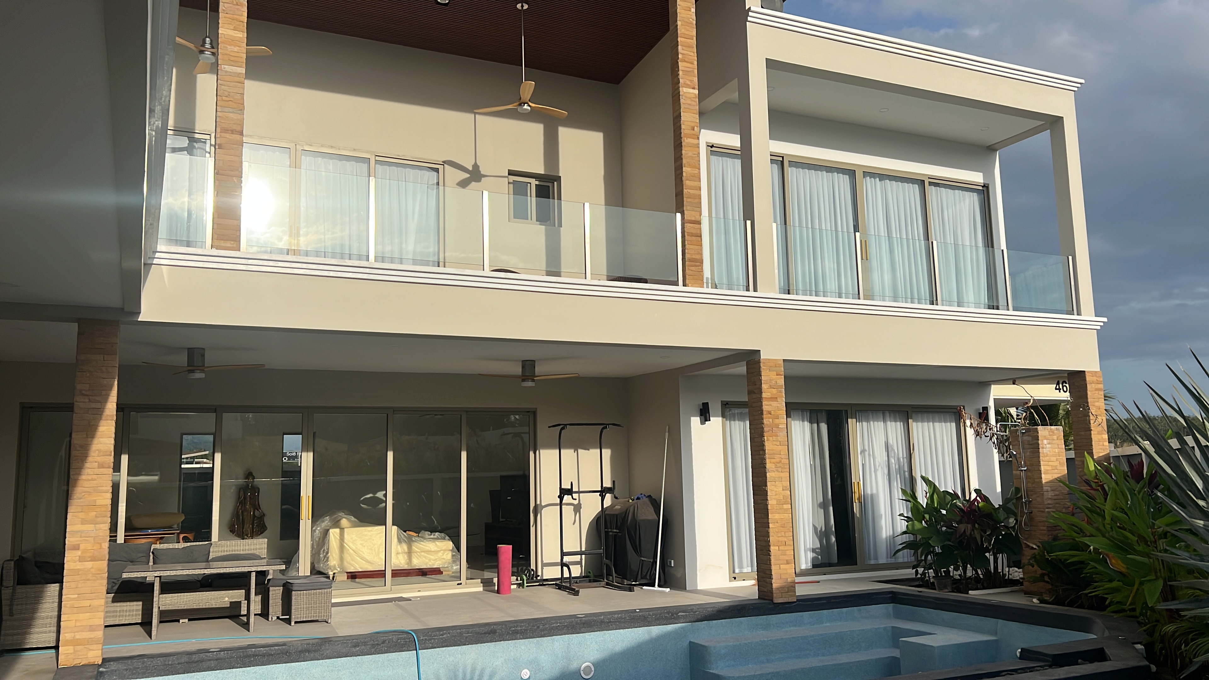 Pool terrace and villa facade at golden hour